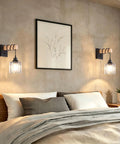 BANGANMA 2-Pack Black Farmhouse Hardwired Wall Sconces Crystal for Bathroom with clear crystal shade beside a bed.