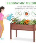 Waist Height Raised Garden Bed With Legs Solid Wood Planter Box On Stand With Liner For Outdoor Use shown with woman watering plants