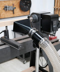 Deluxe Pro Grade Variable Height Dust Extraction Hood with Flexible Rubber Cuff connected to 102mm hose in woodworking setup