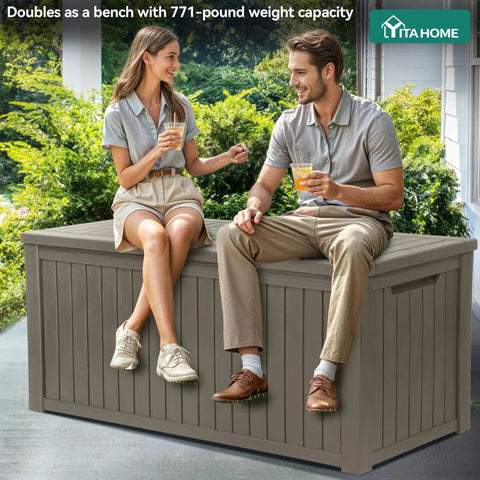 Two people sit on Beefy 220 Gallon XL Outdoor Storage Deck Box with Divider, weatherproof resin, taupe, doubles as bench