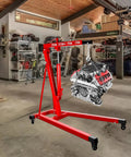 Heavy Duty 5000 Lbs Engine Hoist Cherry Picker with smooth hydraulic lift holding an engine in a garage.