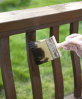 6 Inch Deck Stain Brush With Wooden Handle For Smooth Even Coverage On Wood Decks And Outdoor Surfaces A Big Paint Brush Built For Stains Sealants And Everyday Woodwork being used to stain a wooden railing