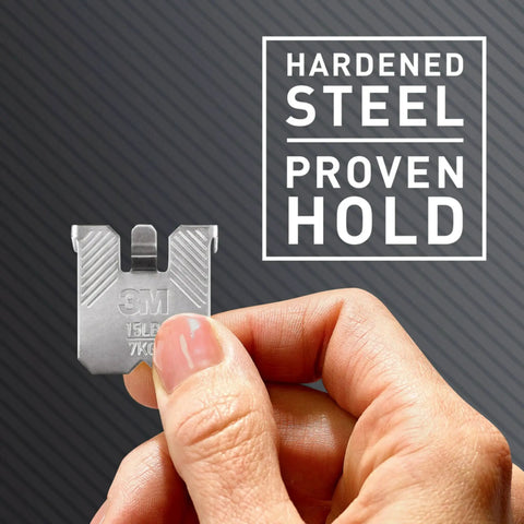 Person holding Claw 15 Lb Drywall Picture Hanger Pack With Spot Markers, showcasing hardened steel proven hold