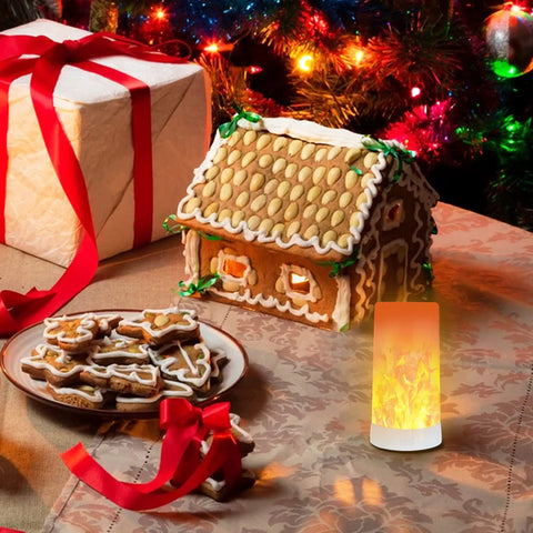 Rechargeable LED Flame Effect Light With Four Modes next to gingerbread house and cookies, creating warm glow
