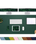 Top view of a dark green Beefy Dual Sided Cork And PU Leather Desk Pad 47 Inch By 17 Inch on a desk with accessories.