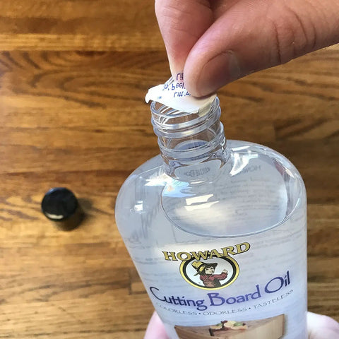 Butcher Block And Cutting Board Oil 12 Oz Pack Of 3 Colorless Odorless Tasteless FDA Approved bottle being opened.