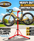 Upgraded Aluminum Bike Repair Stand With 176 Lb Capacity holding a road bike, portable and stable triangular base in outdoor setting.