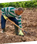 Man using Beast Of A Grass Fork For Manure Handling And Garden Cleanup, Heavy Duty Farm Implement with Rugged Durability on soil