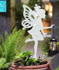 2 Pack Metal Fairy Hanging Lantern Solar Outdoor Garden Stakes With Silhouette Lights in rainy garden setting