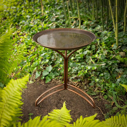Tranquility 20 Inch Copper Bird Bath with pure copper basin bronze finish and durable aluminum base in a garden setting.