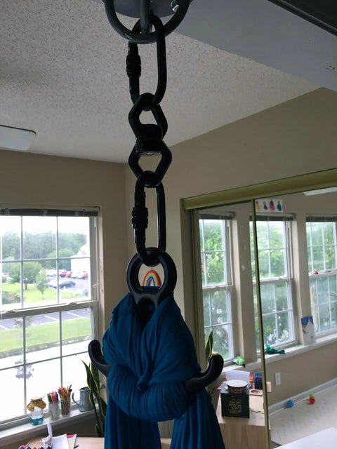 Beefy Industrial Strength Swing Swivel with frictionless 360-degree eye to eye rotation in use with blue aerial rig, aviation aluminum.