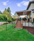 Outdoor Citronella Metal Torch Set Of 4 16 Oz Each Adjustable 59 Inch Garden Torches installed in a backyard pathway