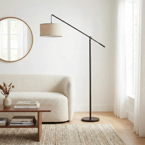 Tall Arc Floor Lamp With Sturdy Base In Rubbed Bronze LED Reading And Living Room Light Adjustable Arm For Dope Mid Century Modern Vibe Bedroom And Office Decor next to sofa in living room.