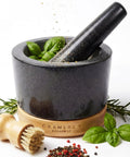 Mortar And Pestle Set Heavy Duty Granite Stone Grinder With Stable Bamboo Base Extra Long Pestle And Cleaning Brush Perfect For Guacamole Bowl Herb Grinding And Molcajete Bowl One Point Five Cup with herbs and spices