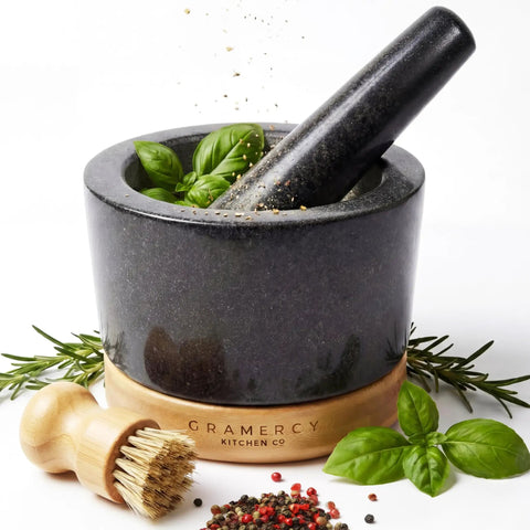 Mortar And Pestle Set Heavy Duty Granite Stone Grinder With Stable Bamboo Base Extra Long Pestle And Cleaning Brush Perfect For Guacamole Bowl Herb Grinding And Molcajete Bowl One Point Five Cup with herbs and spices