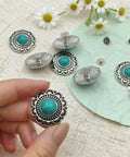 Straight Fire Green Turquoise Concho Buttons 10 Pack With Screw Back Fasteners in hand, showcasing alloy rivets with turquoise center.