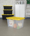 Tough As Nails 27 Gallon Plastic Storage Totes With Secure Locking Lids For Garage Organization 16 Pack in yellow, clear bins with lids.
