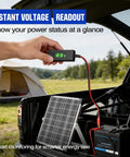 Person checking No-Nonsense 12V Solar Battery Charger With LCD Voltage Tester, 20W Trickle Charger on a truck outdoors.