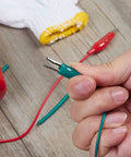 Pro Grade Test Lead And Alligator Clip Set With 20.5 Inch 22 AWG Wires, Five Color Colorway Green White Black Yellow Red, Nickel Plated Clips With PVC Insulators And Heavy Duty Springs, 2 Pack green clip held by hand