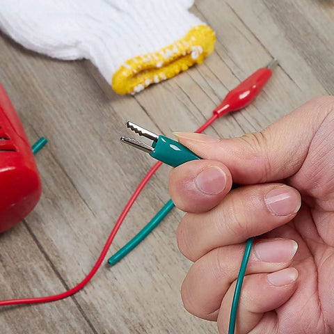 Pro Grade Test Lead And Alligator Clip Set With 20.5 Inch 22 AWG Wires, Five Color Colorway Green White Black Yellow Red, Nickel Plated Clips With PVC Insulators And Heavy Duty Springs, 2 Pack green clip held by hand