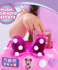 Child pouring syrup into Minnie Mouse Bowrista 10 Inch Kids Espresso Machine Play Set with Cups for pretend coffee shop fun
