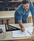 Dead On Twelve Inch Aluminum Rafter Square Top Shelf Carpenter Triangle Ruler Heavy Duty Imperial Layout Protractor on wood table. 