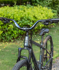 Trail Ready 31.8mm MTB Riser Handlebar 780mm Wide Aluminum Alloy Bar with rise options on mountain bike in garden setting