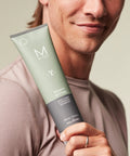 Man holding Heavy Hitter Daily Deep Cleansing Shampoo For Men - All Hair Types, Dirt-Busting Wash, Citrus Agave Scent