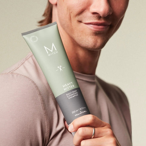 Man holding Heavy Hitter Daily Deep Cleansing Shampoo For Men - All Hair Types, Dirt-Busting Wash, Citrus Agave Scent