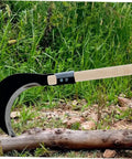 Durable Garden Sickle Handle Replacement with Solid Wood Grip, shown attached to a sickle in a garden setting.