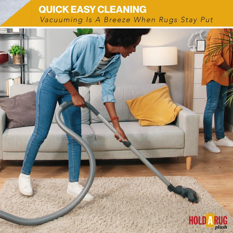 Person vacuuming rug with Nonskid Rug Pad 3' x 5' Plush Reversible Gripper One Quarter Inch Thick, safe for all floors.