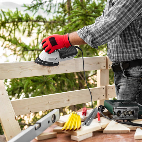 Person using Electric Detail Sander With 12-Piece Sandpaper Set 60 80 100 120 Grit 14,000 OPM on wood furniture outdoors.