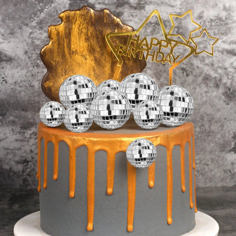 27 Piece Disco Ball Cake Toppers Set With Retro Turntable Dancers And Four Size Options 0.79 In 1.18 In 1.57 In And 1.97 In For 70s Disco Theme Parties Groovy Party Decor That Elevates Any Cake displayed on a two-tier cake with gold drip design.