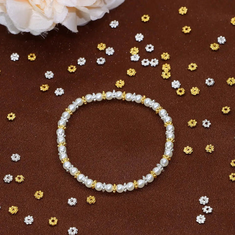 bracelet on brown surface with scattered 4mm mini metal daisy spacer beads bulk 600pcs silver and gold for DIY bracelets and necklaces