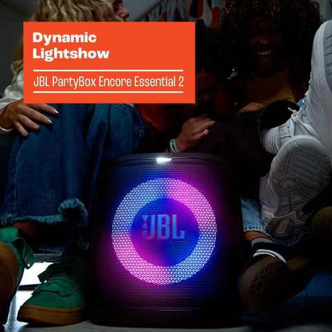 Encore Essential 2 Portable Party Speaker With AI Sound Boost Battery Powered next to people enjoying a light show