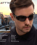 Man wearing tinted safety glasses with UV shield, ideal for construction and outdoor work, highlighting ANSI Z87.1 certification.