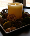 Ivory Grand Pillar Flameless LED Candle with Moving Flame on decorative plate with natural elements, battery powered real wax.