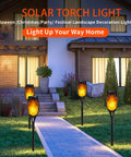 Lit Outdoor Solar Torch Lights Flickering Flame Set Of 12 LED Solar Garden Lights illuminating a pathway at night