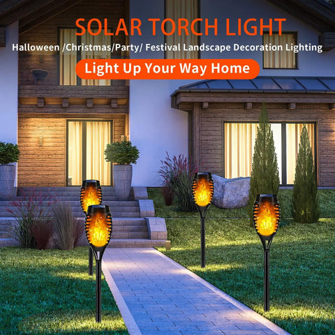 Lit Outdoor Solar Torch Lights Flickering Flame Set Of 12 LED Solar Garden Lights illuminating a pathway at night