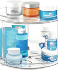 Two Tier Lazy Susan Turntable Organizer For Bathroom And Vanity, Clear 9.25 Inch Rotating Makeup Organizer displaying skincare items