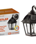 Polaris Solar Light With 130 Lumen LED Bulb For Outdoor Wall Or Pier Mounts 3 Inch Fitter White Finish next to packaging