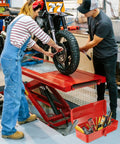 Red Small Metal Tool Box 15 Inch Portable Mini Tool Box With Hip Roof Style Heavy Duty Steel Construction And Corrosion Resistant Powder Coat Finish For Home Garage And On The Go Repairs on workshop floor with tools