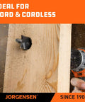Jorgensen spade drill bit in use, drilling a hole in wood; black bit with orange drill handle visible.