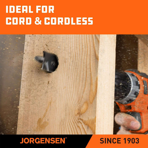 Jorgensen spade drill bit in use, drilling a hole in wood; black bit with orange drill handle visible.
