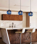 Hand Blown Glass Pendant Light For Kitchen Island Capri Blue Globe Seeded Bubbles Lit Eight Point Seven Inch Diameter 60 Inch Adjustable Cord ETL Listed Modern Ceiling Light over a kitchen island.