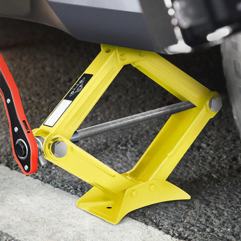 Heavy Duty 1.5 Ton Scissor Jack With Straight Talk Ratchet Design And No Sweat Grip used in a garage raising a vehicle.