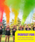 Next Level Party Color Blasters Fire Extinguisher Style Powder Cannon For Gender Reveals And Holi Bash Squeeze Handle Trigger With Viral Smoke Bomb Effect Two Pack Of Neon Green Blast used at an outdoor celebration with vibrant powder.