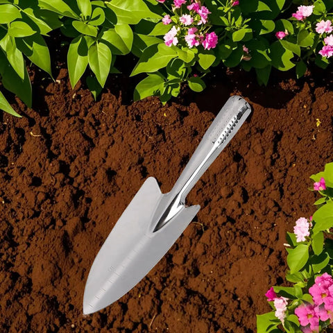 Stainless Steel Garden Trowel And Hand Shovel With Pro Grade Measurement Marks in soil with pink flowers around