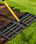 30 Inch Lawn Leveling Rake with 78 Inch Adjustable Steel Handle on grass and soil, rust-resistant stainless steel build