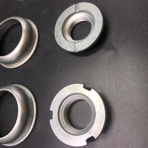 Rock Solid 2 Inch Cup Bottom Bracket Set For One-Piece Cranks Bearings Included Steel Silver components on black background